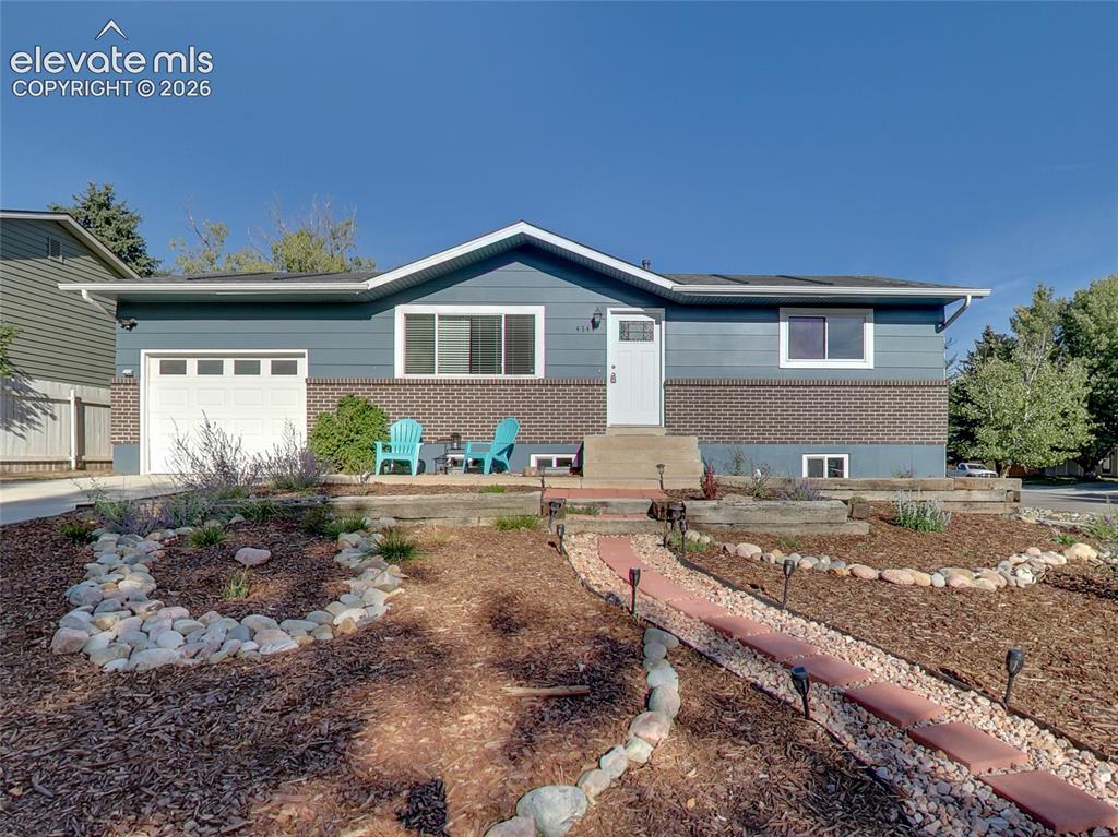 Image 2 of 32: Contemporary siding exterior with a brick accent facade, attached garage, c