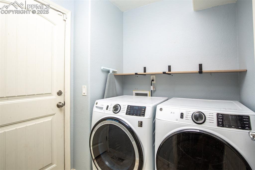 Image 18 of 33: Washroom with washing machine and dryer