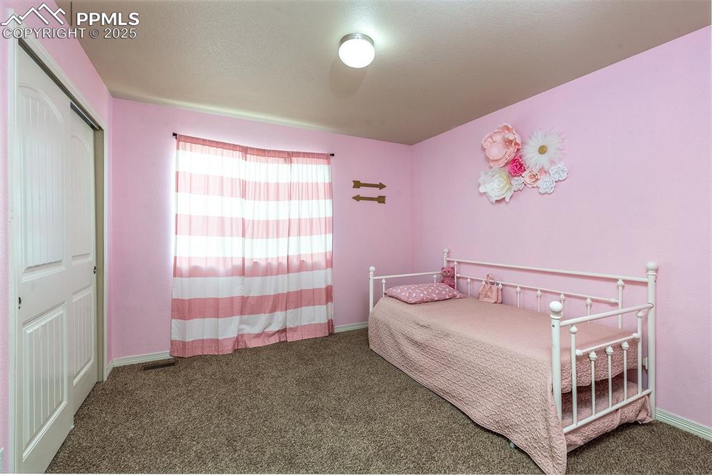 Image 20 of 33: Carpeted bedroom with baseboards and a closet