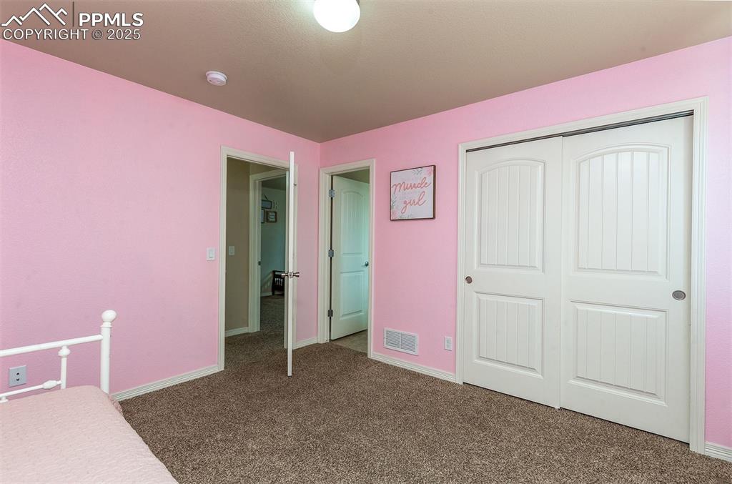 Image 21 of 33: Unfurnished bedroom with carpet floors and a closet