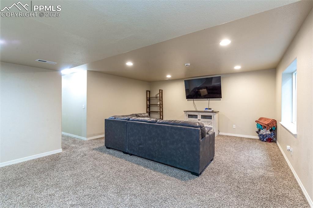 Image 26 of 33: Living area featuring carpet and recessed lighting