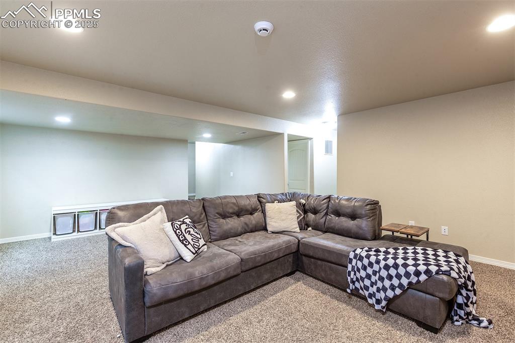 Image 27 of 33: Carpeted living room featuring recessed lighting