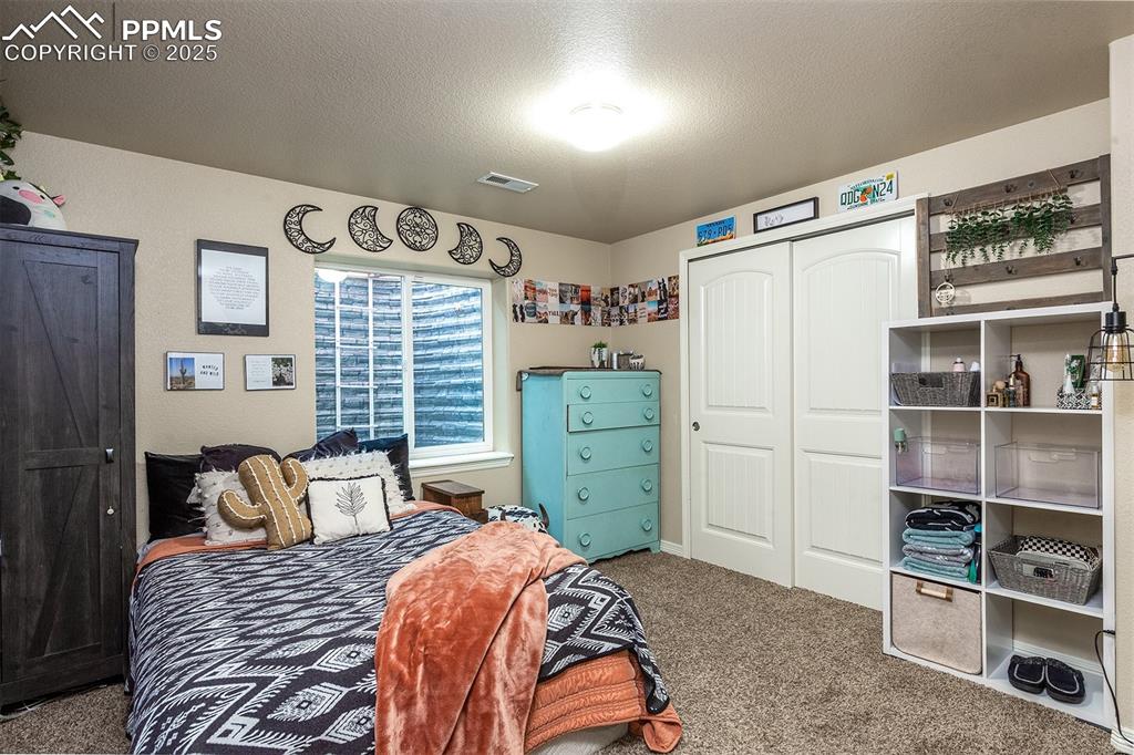 Image 29 of 33: Carpeted bedroom with a closet
