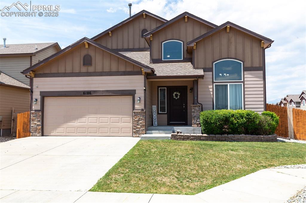 Image 3 of 33: Craftsman house featuring board and batten siding, stone siding, driveway,
