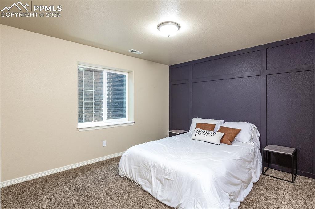 Image 30 of 33: Carpeted bedroom with baseboards