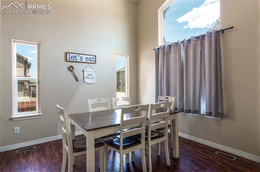 Image 5 of 33: Dining room with dark wood finished floors