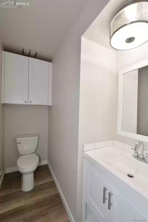 Image 13 of 28: Bathroom with vanity and dark wood-type flooring