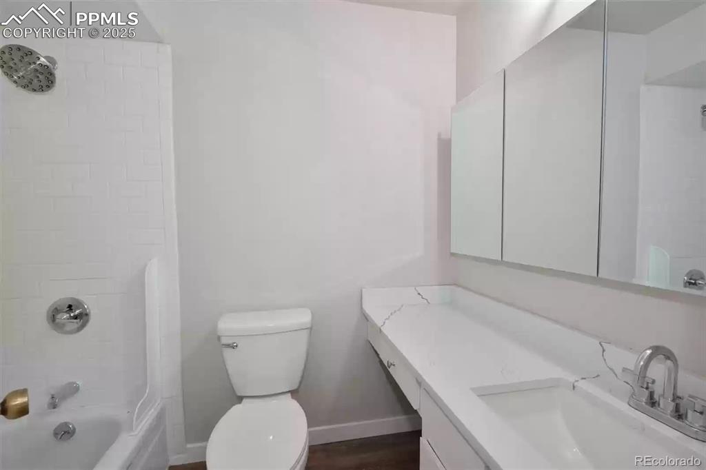 Image 14 of 28: Bathroom featuring vanity and shower combination