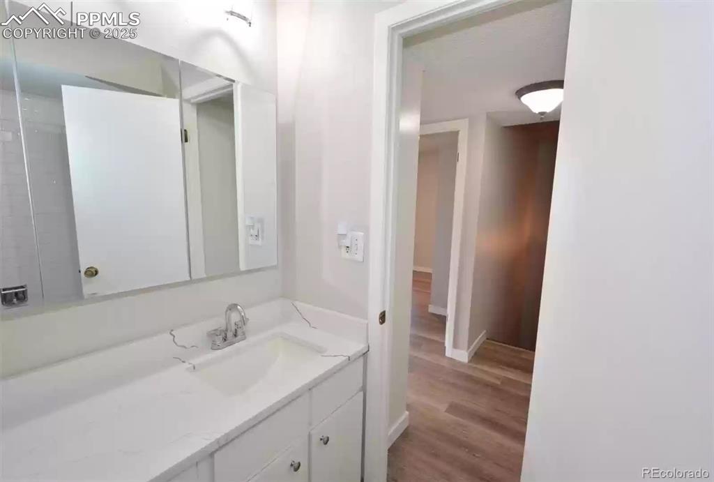 Image 15 of 28: Bathroom with vanity and light wood finished floors