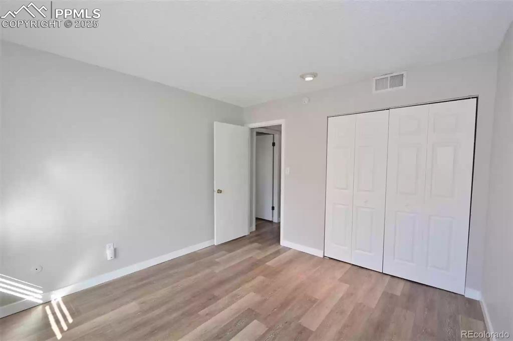 Image 16 of 28: Unfurnished bedroom featuring a closet and light wood-style flooring