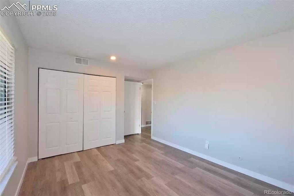 Image 21 of 28: Unfurnished bedroom featuring light wood finished floors, a closet, and rec