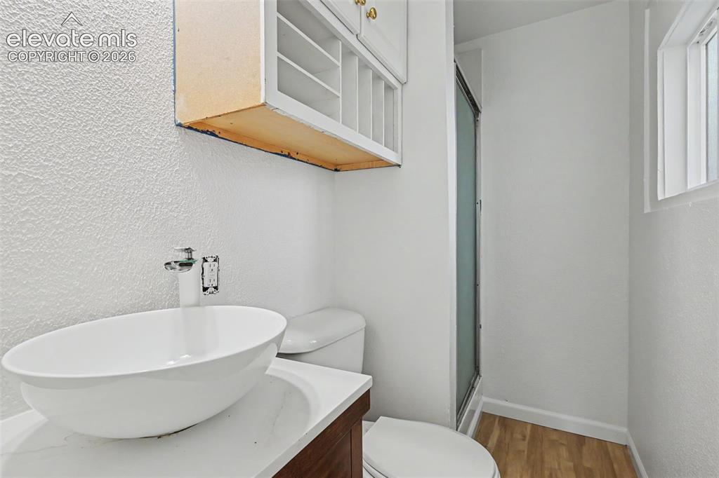 Image 15 of 32: Attached ¾ bathroom with walk in shower and convenient storage
