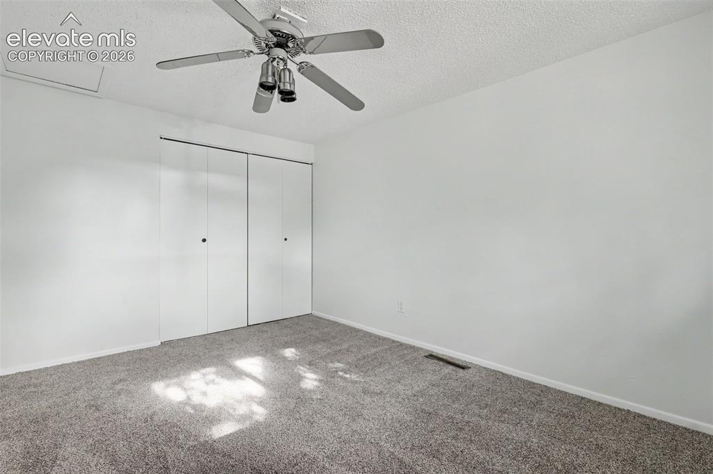 Image 17 of 32: Secondary bedroom with functional layout and closet storage.