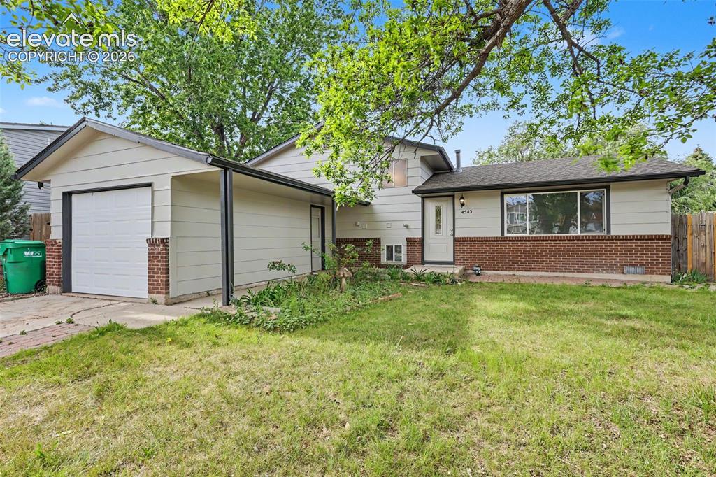 Image 2 of 32: Front exterior with mature trees, covered entry, and updated exterior paint