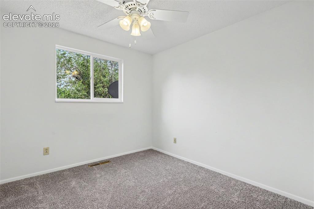 Image 21 of 32: Upper level bedroom with closet storage and updated flooring.
