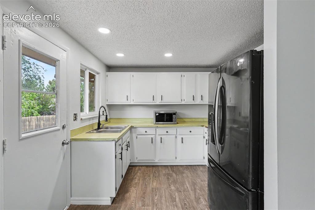 Image 6 of 32: Freshly painted cabinets help give this kitchen a clean and refreshed feel.