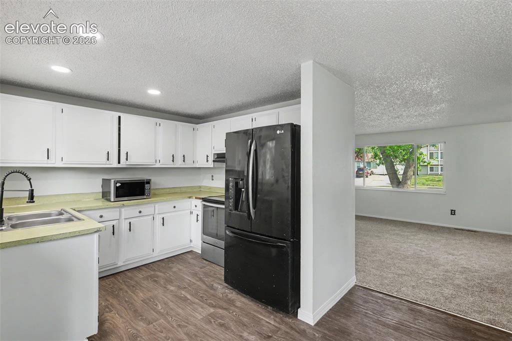 Image 7 of 32: Clean and functional kitchen with room to make it your own over time.