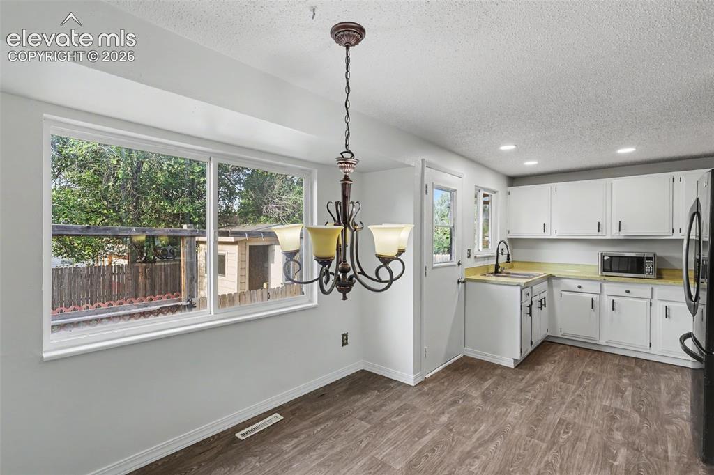 Image 8 of 32: Functional kitchen layout with open flow into the dining area.