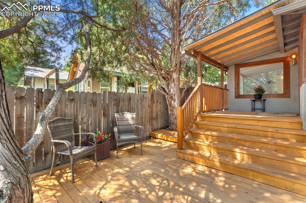 Image 2 of 32: New front deck with built-in bench and planters