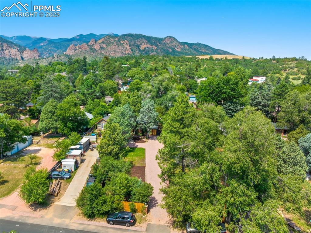Image 27 of 32: Property is the driveway on the right and north Cheyenne Canon is in the ba