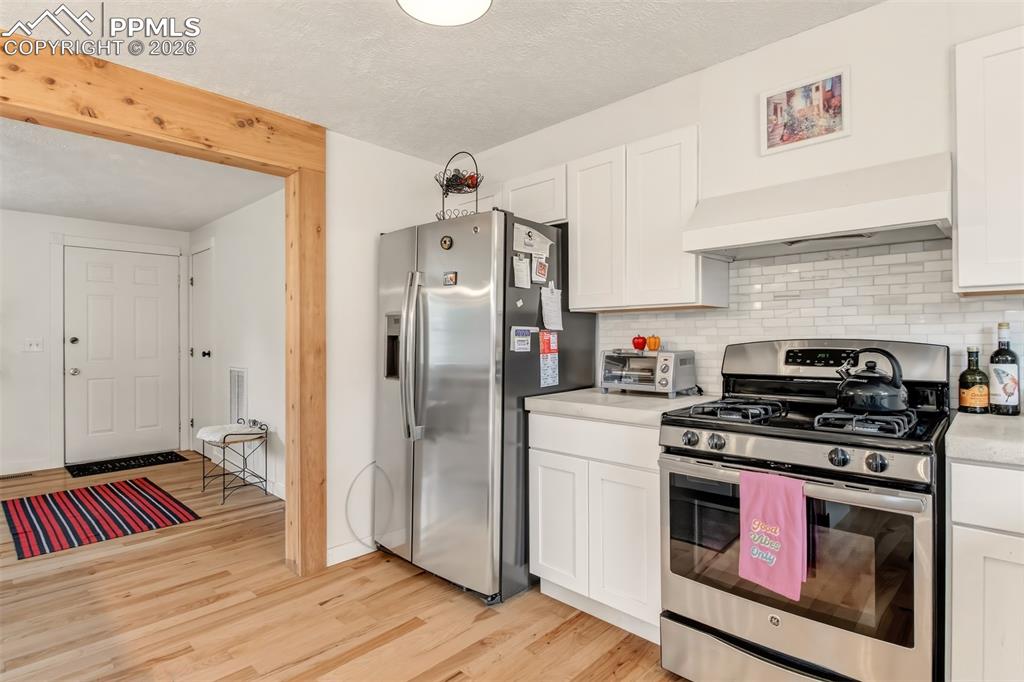 Image 10 of 31: Open concept farmhouse kitchen, with concrete countertops, matching applian