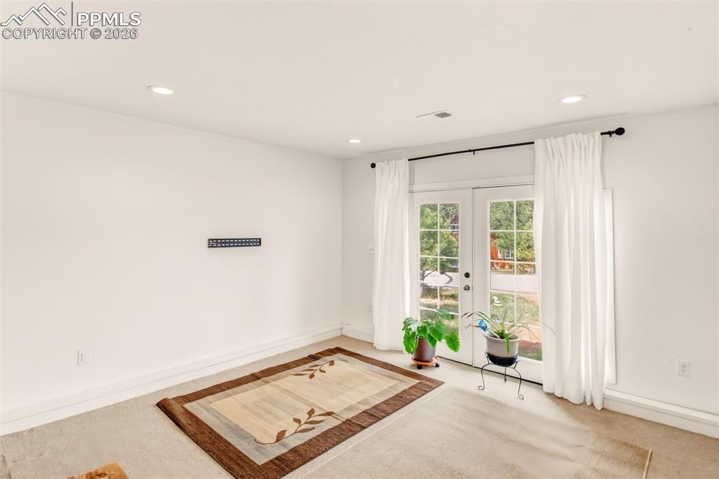 Image 21 of 31: Bonus room with French doors an attached 3/4 bathroom and laundry room