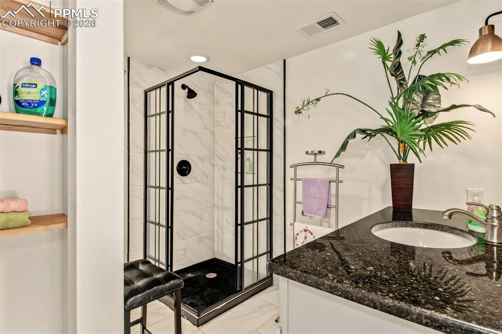 Image 22 of 31: 3/4 bathroom off the bonus room with radiant in floor heating
