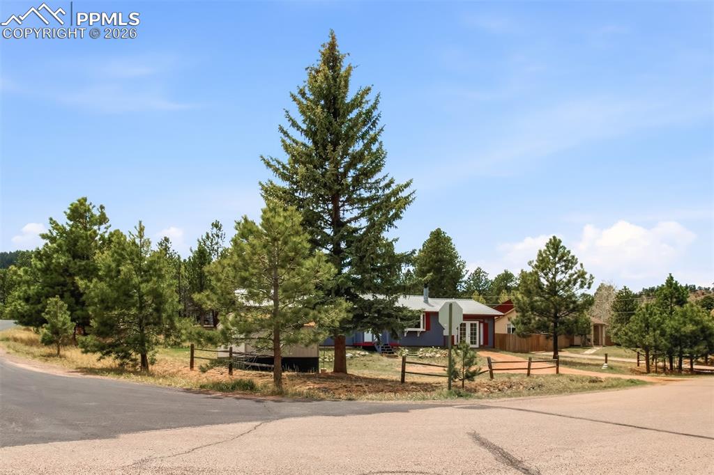 Image 3 of 31: Front of home, highlighting the spacious corner lot