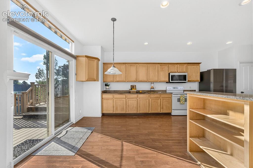 Image 12 of 50: Eat-in kitchen leads out to the deck