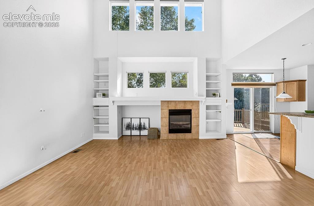 Image 7 of 50: Family room with fireplace and built ins