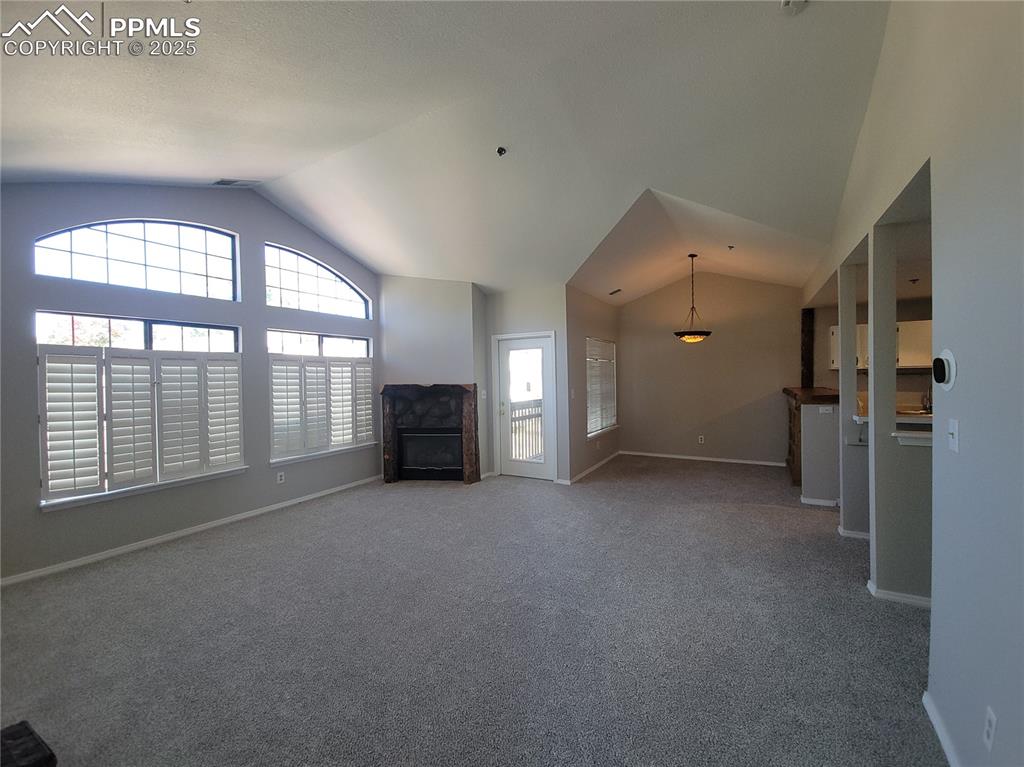 Image 6 of 19: Huge open living area with fireplace