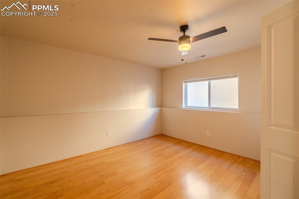 Image 17 of 36: Spare room with wood finished floors and ceiling fan