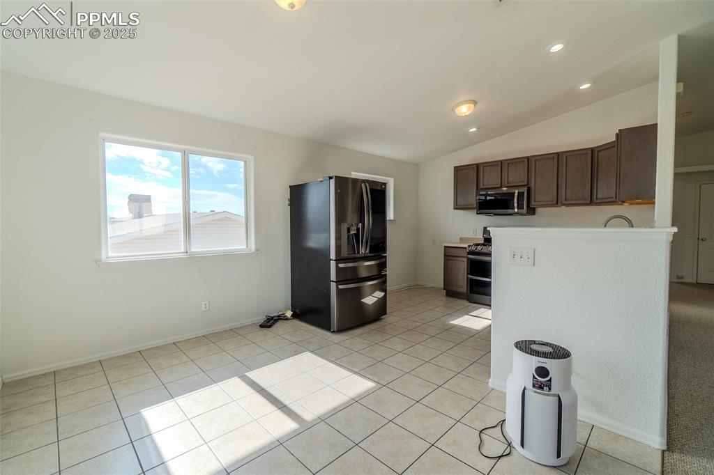 Image 36 of 36: Kitchen featuring stainless steel appliances, light countertops, vaulted ce