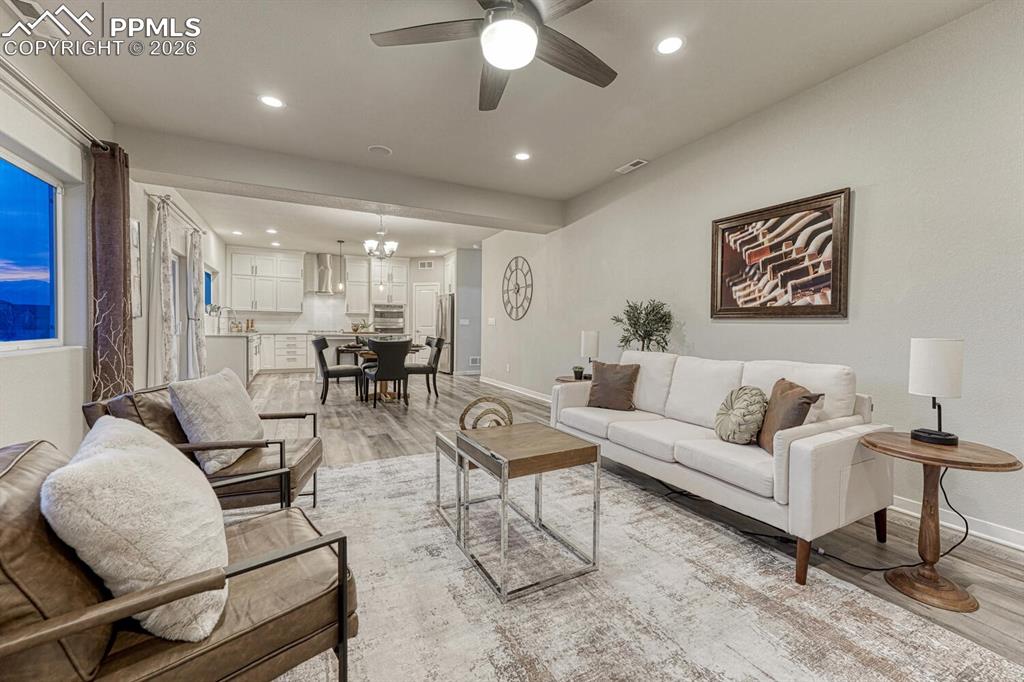 Image 14 of 50: Living room with ceiling fan, light wood-type flooring, and recessed lighti
