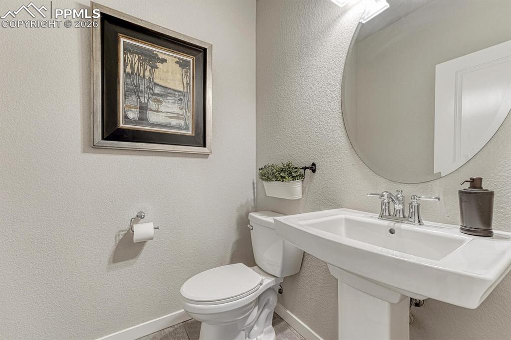 Image 21 of 50: Bathroom with a textured wall and toilet