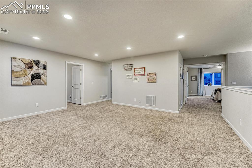 Image 23 of 50: The great size of the loft is complemented by light carpet and recessed lig