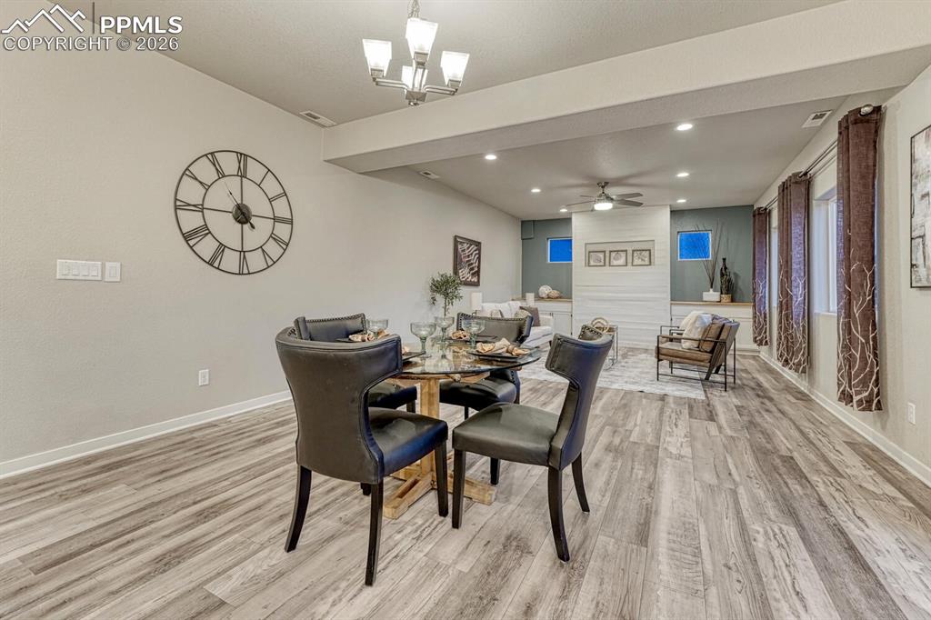 Image 9 of 50: Dining space with ceiling fan, light wood-style floors, and recessed lighti