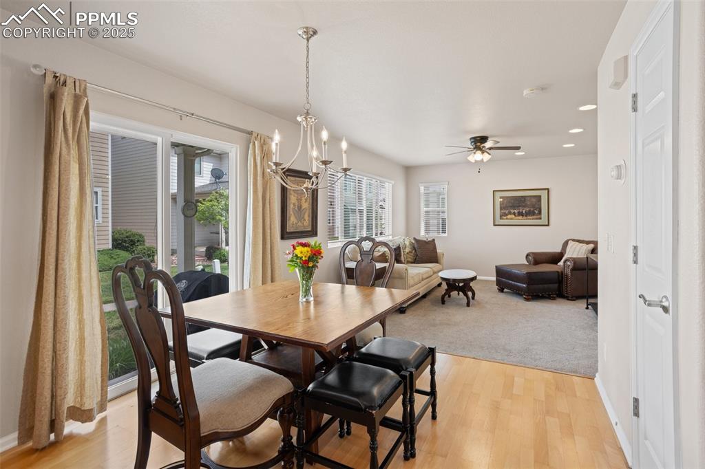 Image 6 of 26: Dining space with a chandelier, recessed lighting, ceiling fan, light wood-