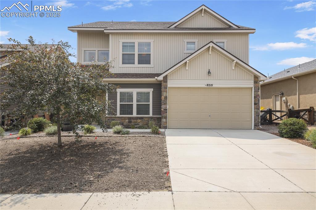 Caption: View of front of home with a garage