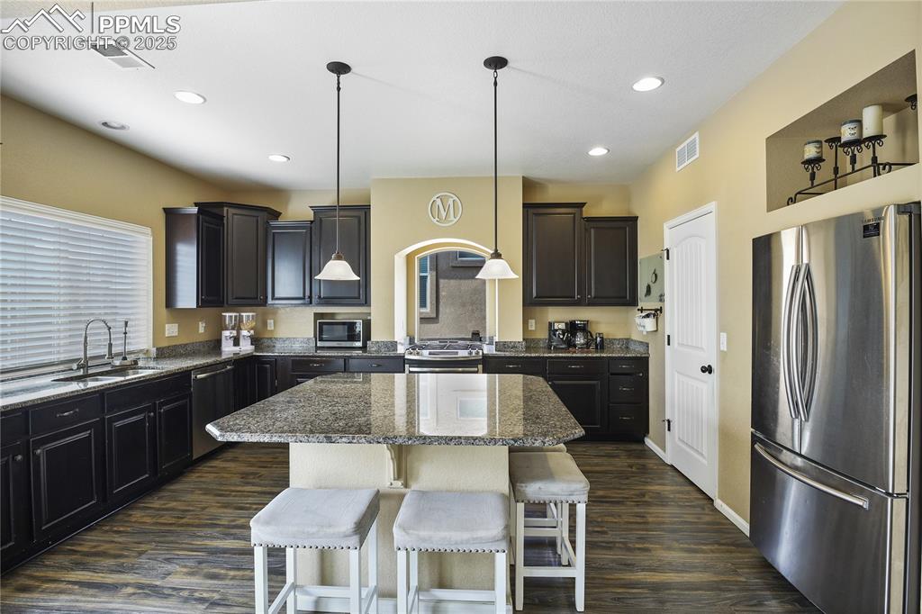 Image 11 of 38: Kitchen featuring dark hardwood / wood-style flooring, stainless steel appl