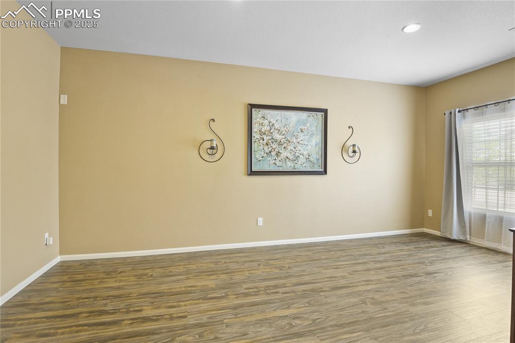 Image 17 of 38: Spare room featuring dark hardwood / wood-style flooring