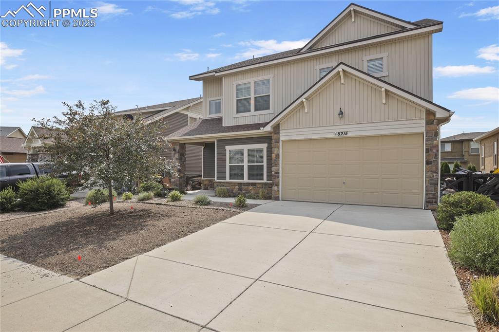 Image 2 of 38: View of front of property with a garage