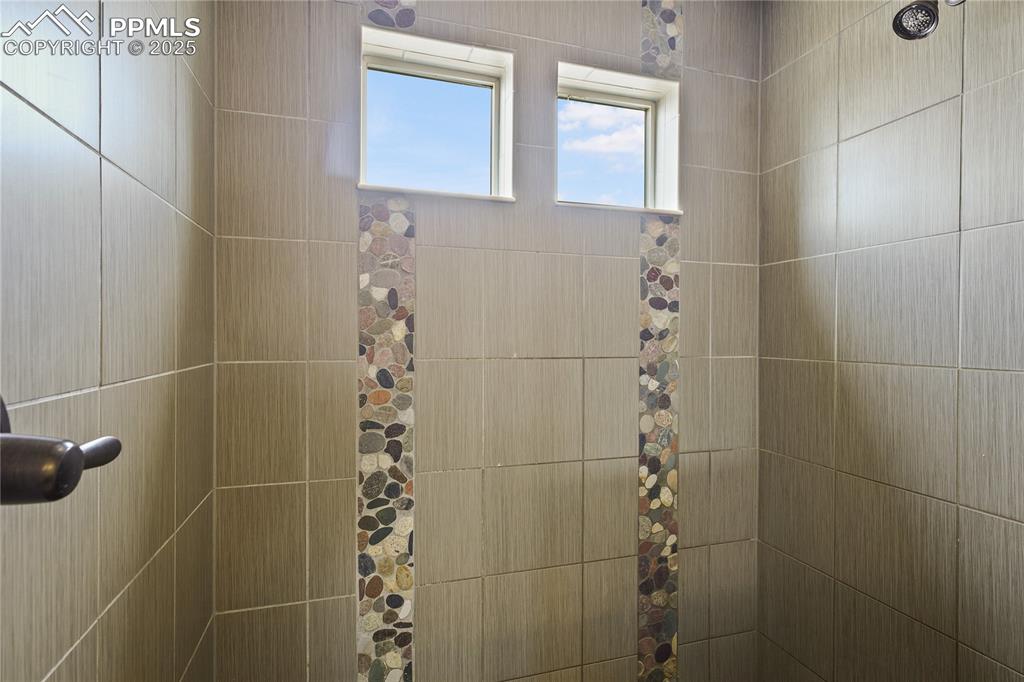 Image 22 of 38: Bathroom featuring tiled shower