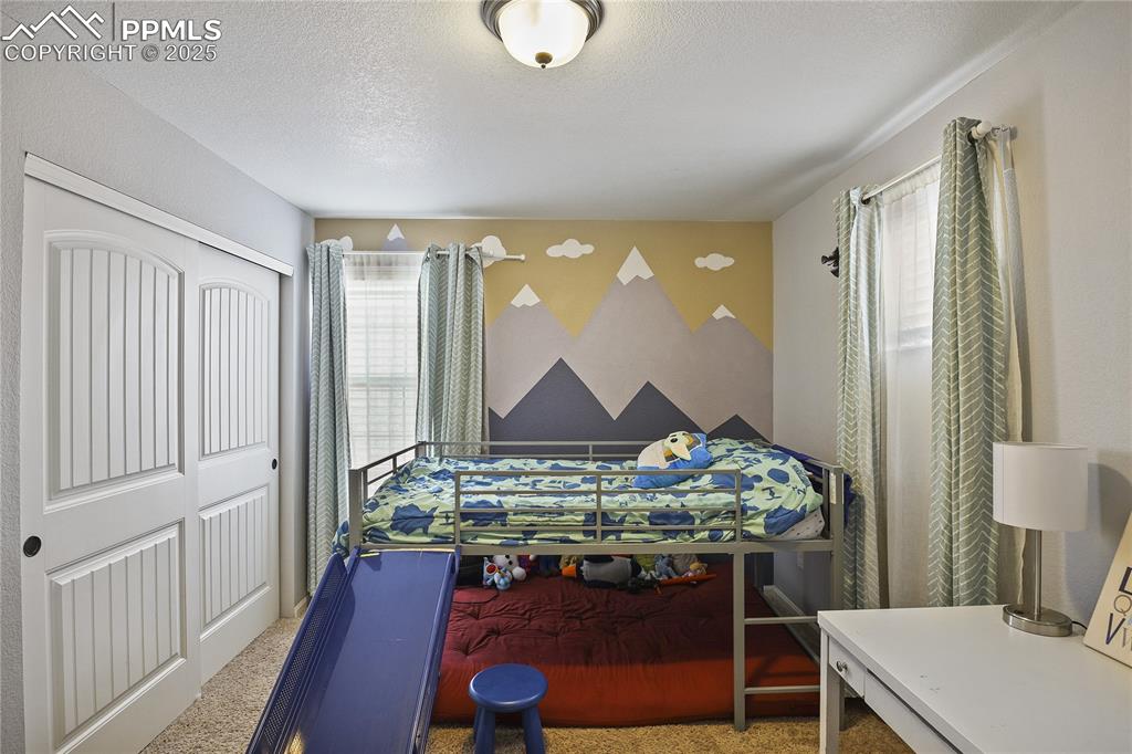 Image 29 of 38: Carpeted bedroom featuring a closet and a textured ceiling