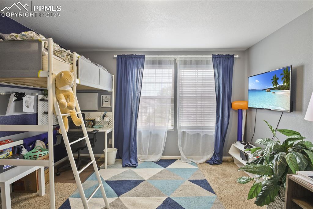 Image 31 of 38: Carpeted bedroom with a textured ceiling