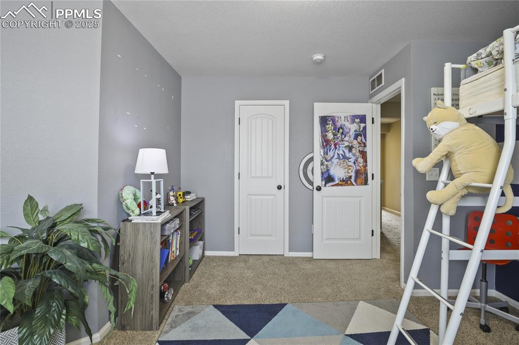 Image 32 of 38: Carpeted bedroom featuring a textured ceiling