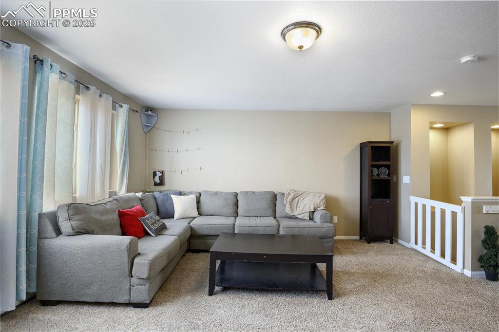 Image 36 of 38: Living room with carpet flooring