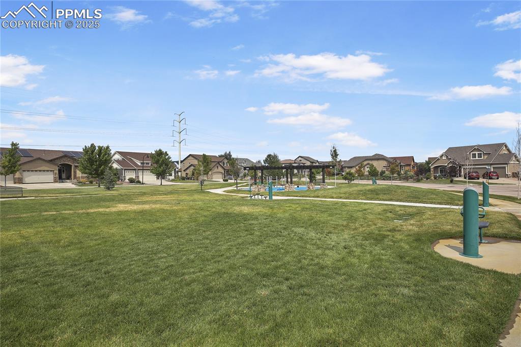 Image 38 of 38: View of community featuring a lawn