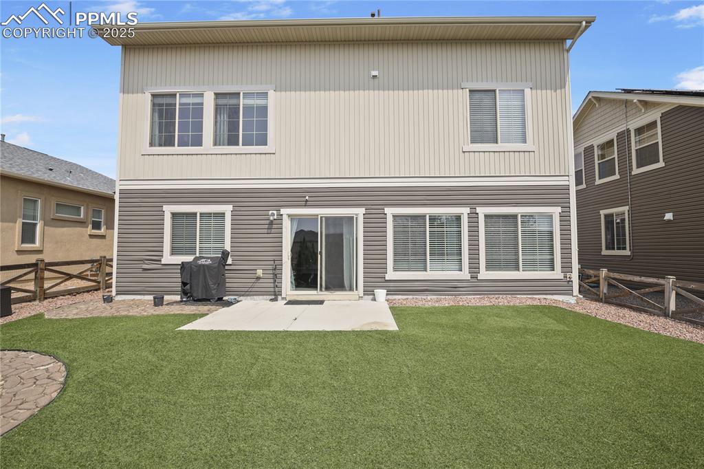 Image 4 of 38: Back of property with a patio area and a yard