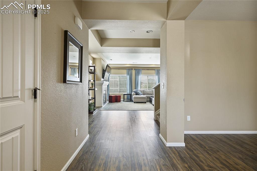 Image 7 of 38: Hall featuring dark wood-type flooring